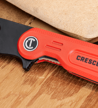 Crescent Hybrid Folding Utility Knife on wood block